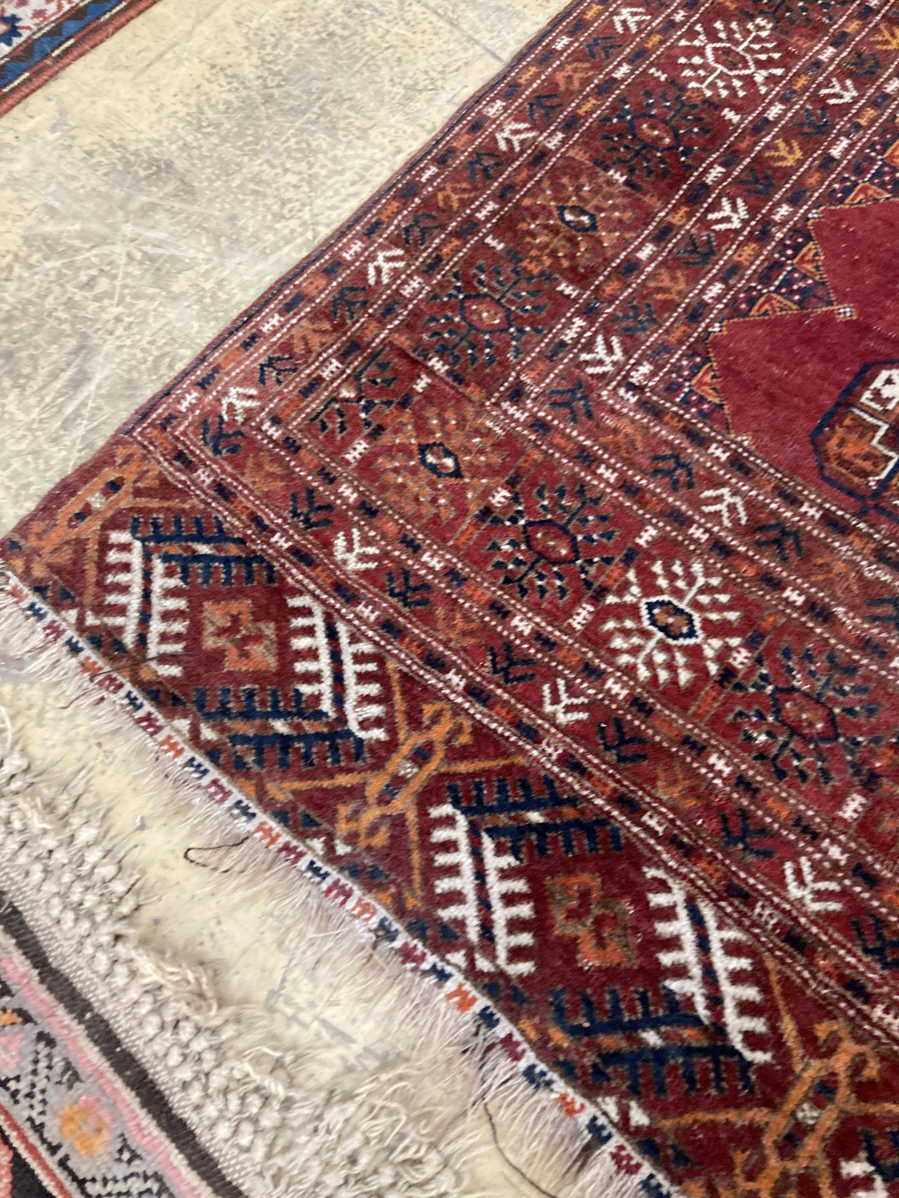 A Bokhara red ground rug, 190 x 114cm